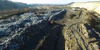 航拍:推土机在一个巨大的垃圾场里铲垃圾