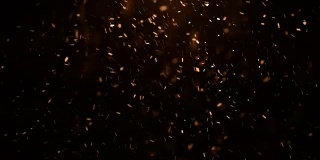 发光的雪粒在空气中飞行火花颜色的黑色背景
