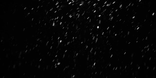 发光的雪粒在空气中飞行火花颜色的黑色背景