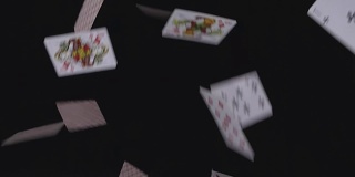 许多扑克牌以慢动作落在黑色背景上
