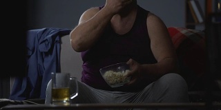 肥胖男子看喜剧秀暴饮暴食垃圾食品，被动休闲在家