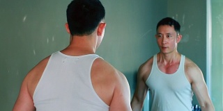 英俊健美的亚洲运动男子在健身房做哑铃卷曲练习。-股票视频