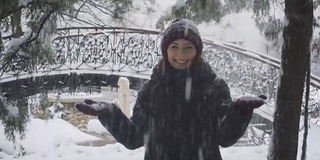 年轻女子在户外享受冬日。雪的冬天的梦想。慢动作