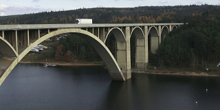 河上的车辆往来。桥的建筑外观在河上。河上的混凝土桥。