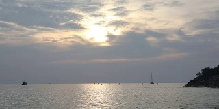 远处站立的划船者在平静的海面上划船