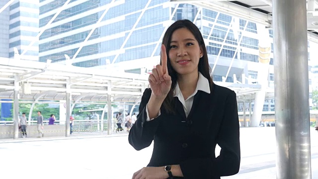 business woman working at urban Skyline , index finger in air