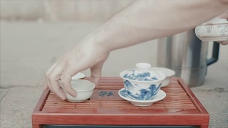 传统的中国茶道。视频。男子手套中国茶杯特写。中国的饮茶仪式。倒茶喝视频素材模板下载