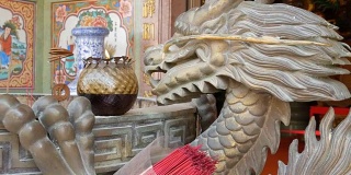 中式原创烛台。附近有一尊龙的铜像和一根燃烧的蜡烛