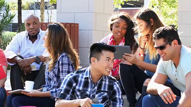 A group of young adult college students on campus.