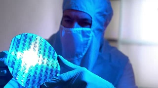 洁净室技术人员正在检查一个硅片微芯片磁盘视频素材模板下载