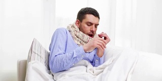 生病的男人得了流感在家打喷嚏和擤鼻涕