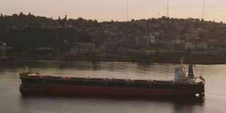 日出时西雅图天际线前的一艘大船。