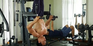 年轻的亚洲健美男在健身房锻炼腹肌，健康的生活理念