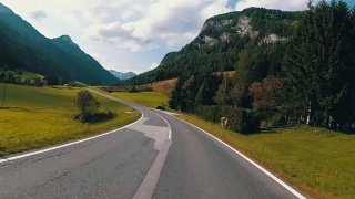 奥地利，骑摩托车的人在风景优美的山路上。第一人称视角视频素材模板下载