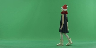 小女孩戴着圣诞帽走路，背景上有色度键