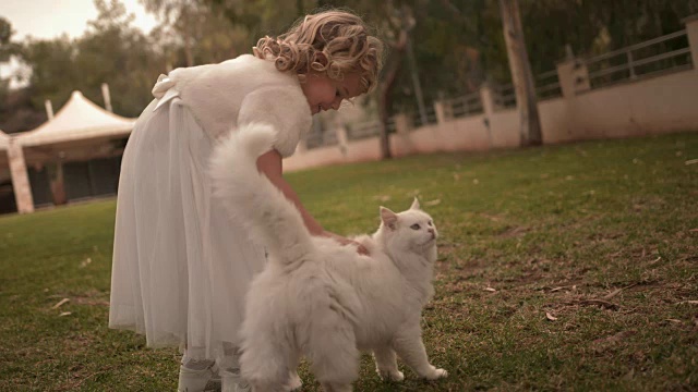 快乐的花童抱着篮子和宠物猫在婚礼上