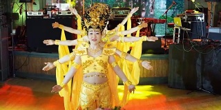 五名亚洲女演员组成的一组，穿着中国传统的黄色服装，跳着“多臂女神”的舞蹈