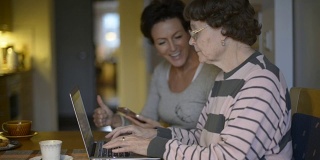 Senior Woman At Home Learning To Use Laptop Computer