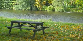 苏格兰秋天的树林长椅和美丽的河流