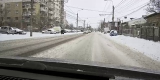 一场大雪过后，汽车载着雪行驶在城市道路上