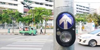 交通信号用电。路边有交通标志。要过马路时按一下按钮。