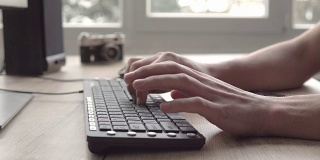 在键盘上打字。在电脑键盘上打字的人。人的手用电脑键盘和鼠标打字。自由摄影师与电脑工作。
