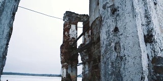被毁的旧建筑红砖墙在冰冻的湖中央