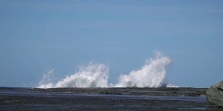 慢镜头海浪撞击海岸岩石，溅起巨大水花