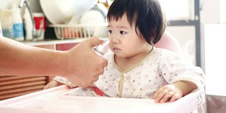 4k:母亲在一岁的女婴鼻子里喷药、滴鼻喷雾。