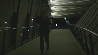 Man Running at Night Alone in Dark City视频素材模板下载