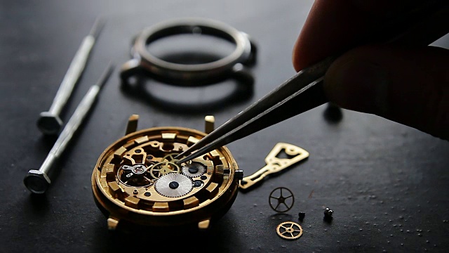 Watchmaker is repairing a mechanical watches