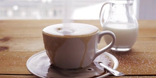 糖洒在木桌上的咖啡杯上