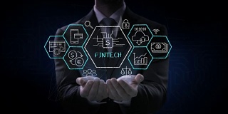 商人打开两只手掌，金融科技图标和各种图形。未来的金融技术。4 k的电影。版本1。
