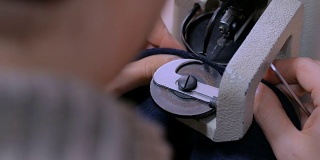 斯金纳在工作室使用缝纫机缝制毛皮