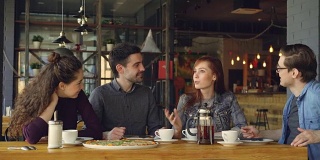 一群快乐迷人的男女朋友在小咖啡馆或披萨店里一起谈笑风生。沟通与餐饮服务理念。