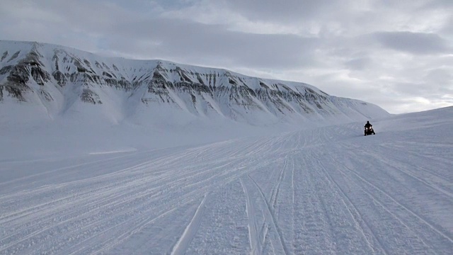 People expedition on snowmobile in North Pole Spitsbergen Svalbard Arctic.