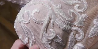 特写珠和亮片，针和线，绣花图案。用于缝制优雅婚纱的设备。手工制作的