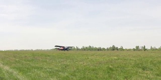 轻型单引擎飞机从绿色的田野起飞升入天空
