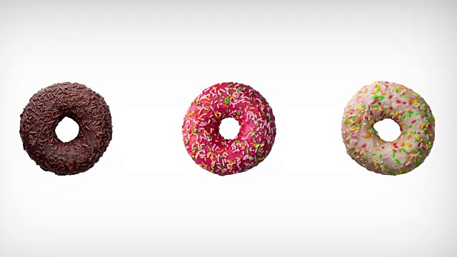三个不同颜色的甜甜圈在白色背景上的抽象旋转动画。
