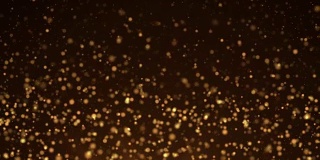 金粒子。自然漂浮的有机颗粒在美丽的背景。闪烁粒子与散景。缓慢的运动。