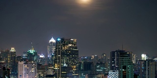 超级月亮升起的时间流逝，融化了天空中的云在曼谷与城市景观的位置