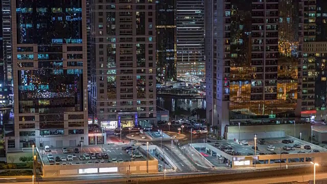 Aerial view of Jumeirah lakes towers skyscrapers night timelapse with traffic on sheikh zayed road