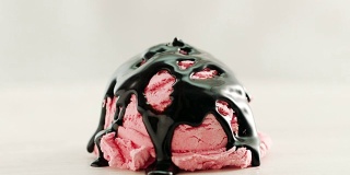 草莓冰淇淋覆盖着巧克力酱和白巧克力片