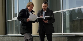 Business team discussing papers outdoor