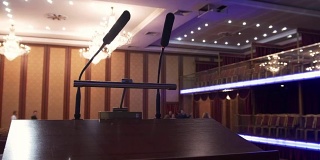 空礼堂前的舞台上有两个麦克风——商务会议