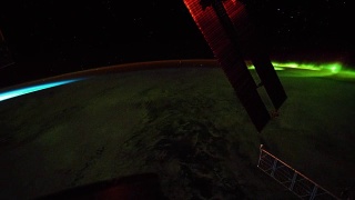 在地球北极上空看到的明亮的绿色极光。前景中可以看到国际空间站的太阳能电池板。图片由美国宇航局约翰逊航天中心地球科学和遥感单元提供。由Rebus_Prod处理。视频素材模板下载