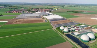镜头从猪场的沼气厂上空飞过。生物质的可再生能源。现代农业欧盟。鸟瞰图，从空中俯瞰全景