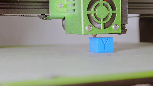 一个带字母的蓝色立方体的3D打印侧视图