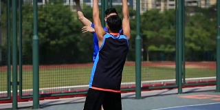 年轻的亚洲成年人在户外打篮球