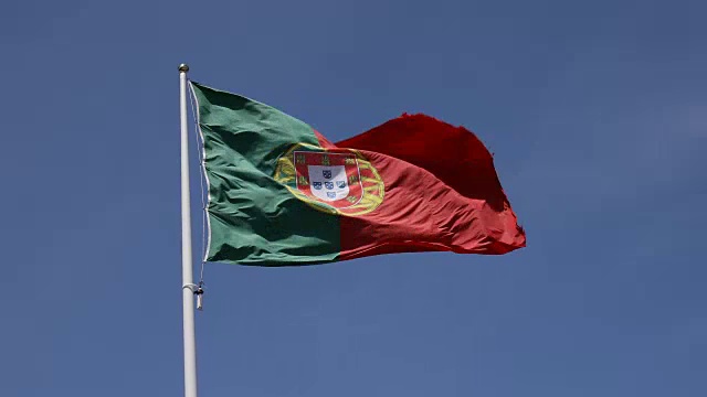 蓝色天空中飘扬的葡萄牙国旗